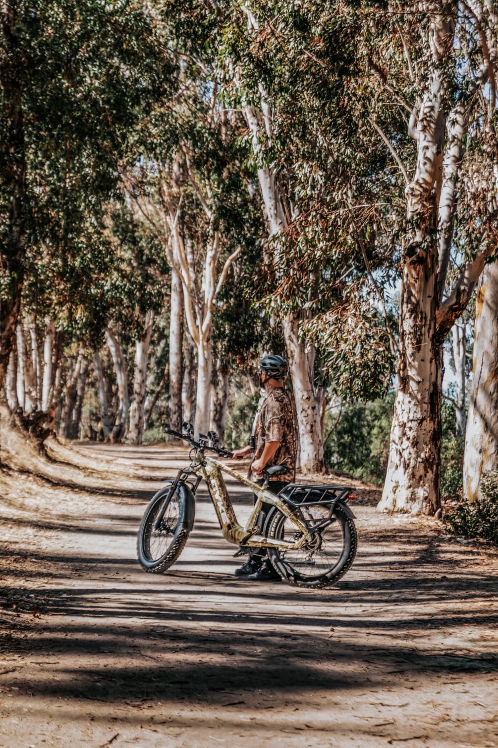 Soft tail mountain bike navigating uphill on a rocky trail.